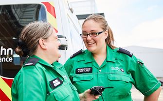 Two Advanced First Aiders by an ambulance Two Advanced First Aiders by an ambulance