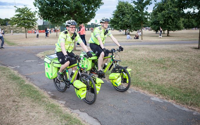 Pair of Emergency Cycle Responders cycling through a park