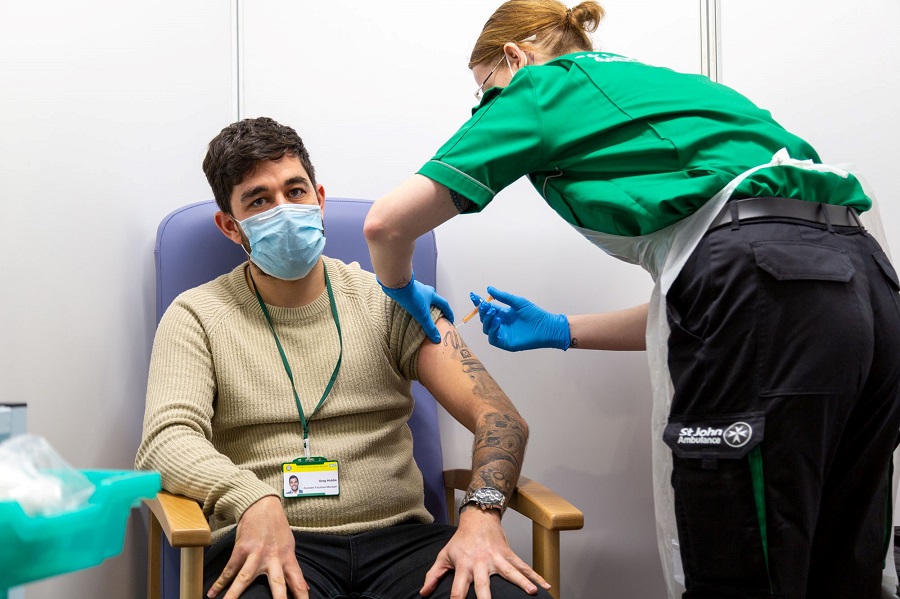 St John Ambulance volunteer delivering vaccine