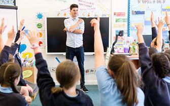 Class of primary school children learning