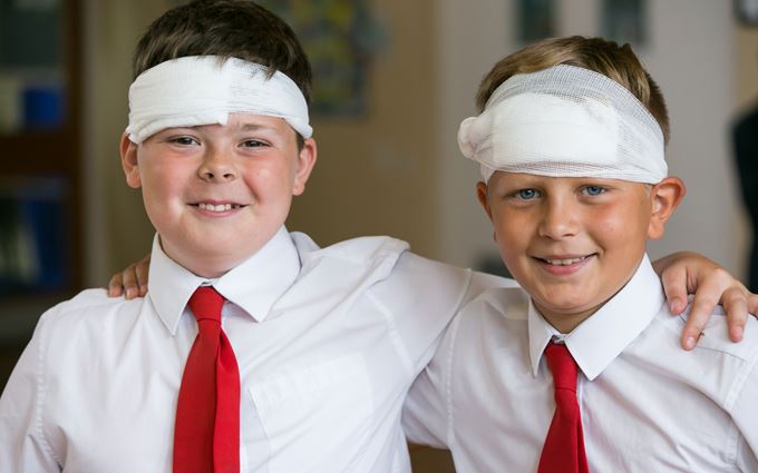Two school children with bandages on their heads Two school children with bandages on their heads