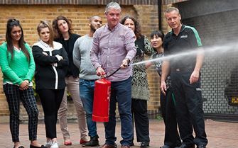 Fire marshal training class learn to use a fire extinguisher