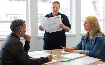 St John Ambulance trainer and participants on a managing safely course