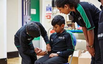 Two Badgers practising bandaging an arm Two Badgers practising bandaging an arm